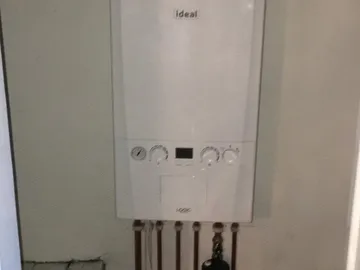A newly fitted Ideal boiler with neat copper pipework underneath